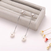 Sterling Silver Long Bow Pearl Earrings - Glöd of Sweden