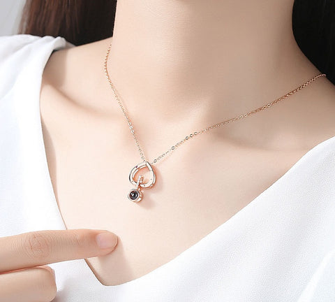 Girl Wearing 100 Language I Love You Heart Necklace 