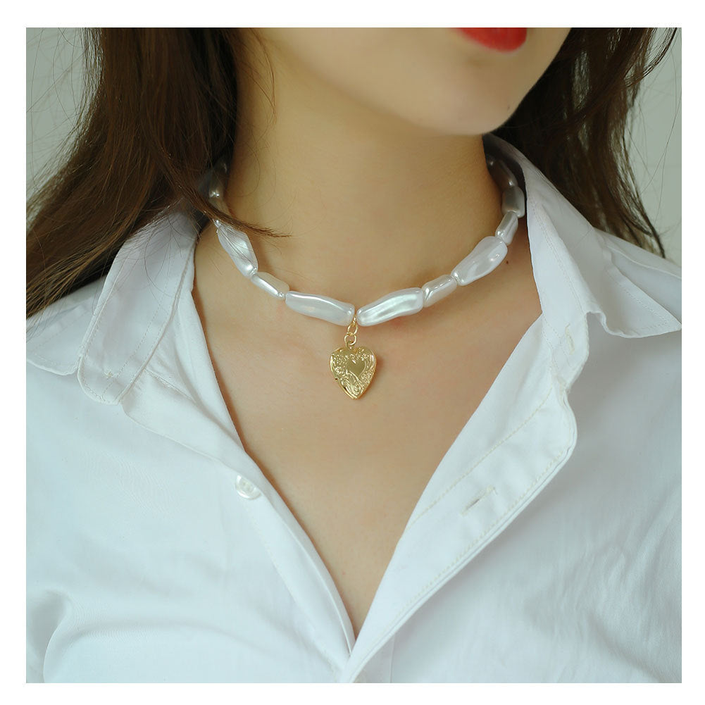 Woman Wearing Timeless Gold Heart Pendant Pearl Necklace